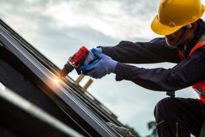 Homeowner checks roof edges and gutters from the ground beside a house before vacation.